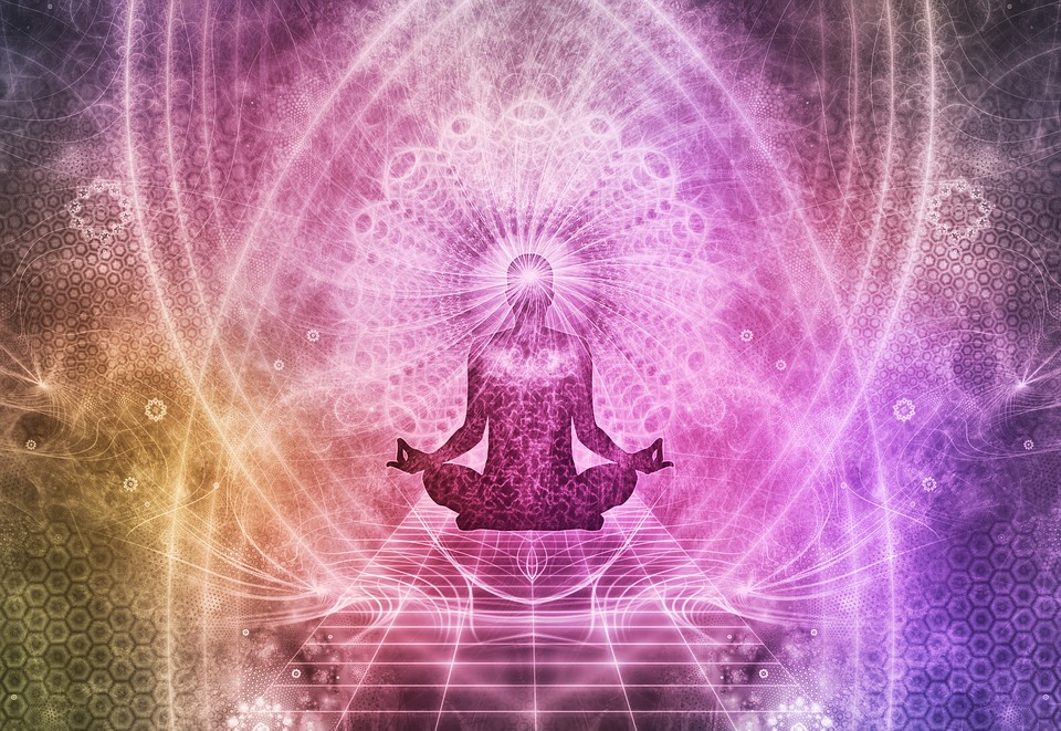 Person meditating with cool colors and patterns emitting from the third eye.